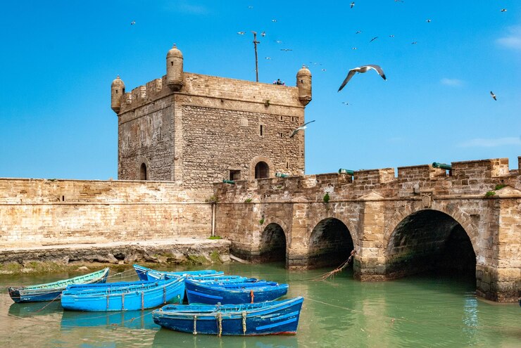 blue-fishing-boats-fortifications-tower-citadel-mogador-essaouira-morocco_572133-773